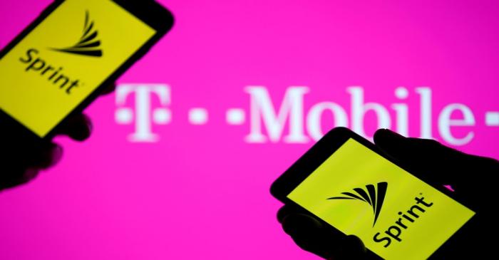 FILE PHOTO: A smartphones with Sprint logo are seen in front of a screen projection of T-mobile