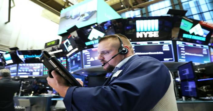 A trader works on the floor of the New York Stock Exchange (NYSE) near the close of market in