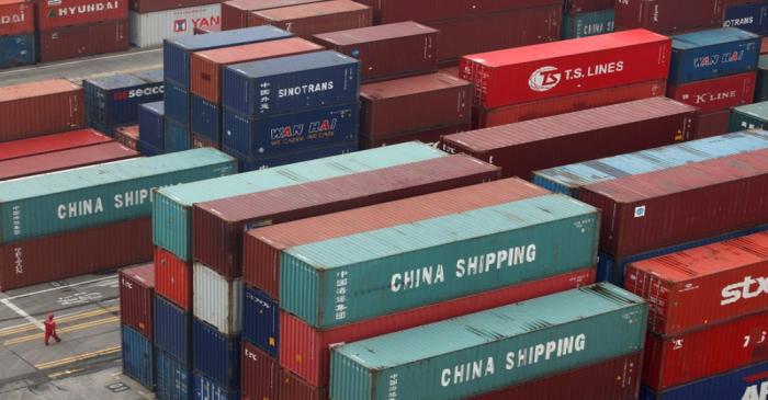 FILE PHOTO: A worker walks in a shipping container area at the Port of Shanghai