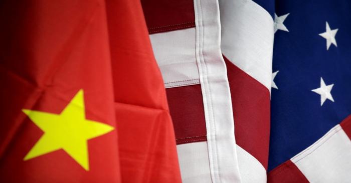 Flags of U.S. and China are displayed at AICC's booth during China International Fair for Trade