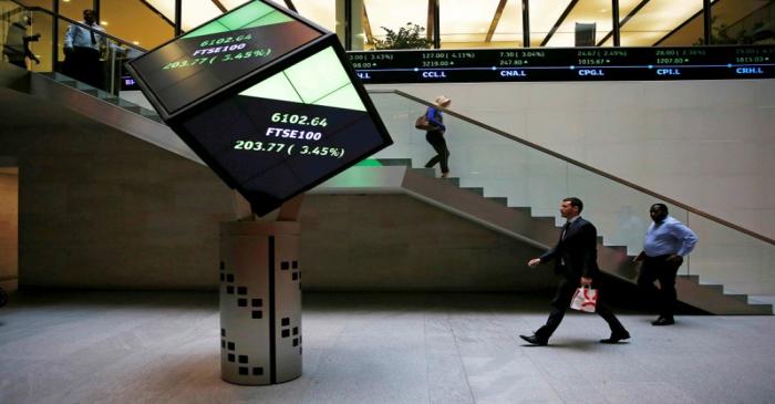 People walk through the lobby of the London Stock Exchange in London