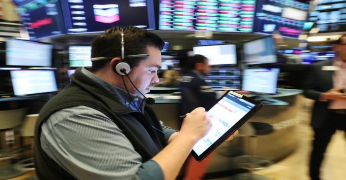 Traders work on the floor of the New York Stock Exchange shortly after the opening bell in New