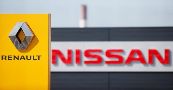 The logos of car manufacturers Renault and Nissan are seen in front of dealerships of the