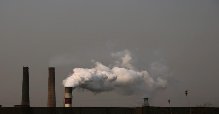 Smoke rises from a chimneys of a steel mill on a hazy day in Fengnan district of Tangshan,