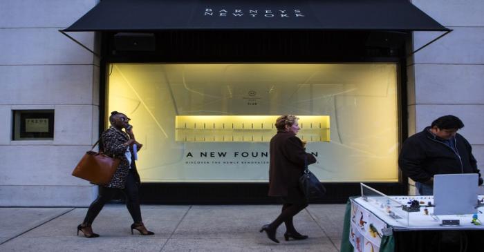 FILE PHOTO - People walk by a Barneys New York retail store in New York