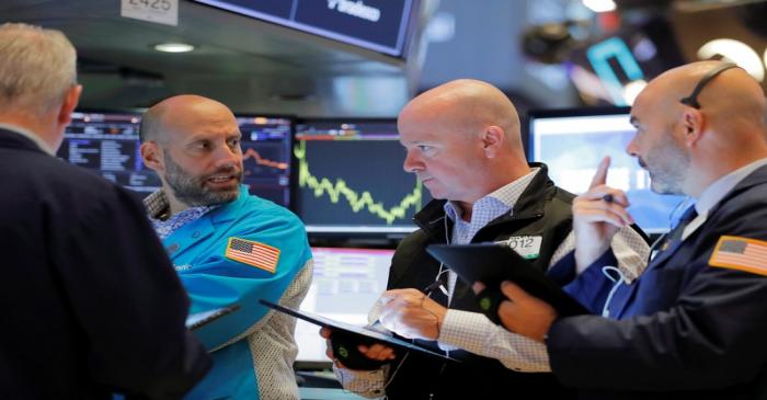 Traders work on the floor of the New York Stock Exchange shortly after the opening bell in New