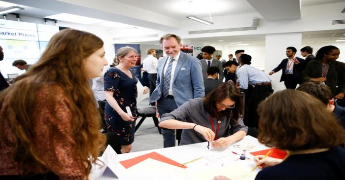 Britain's Chief Trade Negotiation Adviser Crawford Falconer watches students take part in a