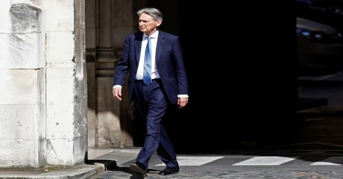 FILE PHOTO: British Chancellor of the Exchequer Philip Hammond walks near the Parliament