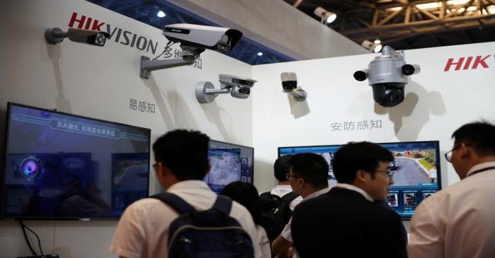 FILE PHOTO: People visit the HIKVision booth at the security exhibition in Shanghai