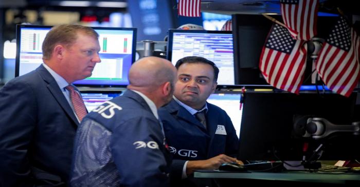 FILE PHOTO: Traders work on the floor at the NYSE in New York