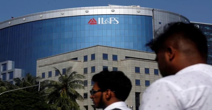 People walk past a building of IL&FS outside its headquarters in Mumbai