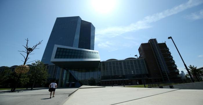 FILE PHOTO: A man walks towards the European Central Bank (ECB) headquarters in Frankfurt,