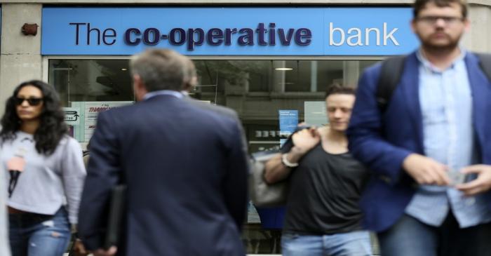 People walk past a branch of the Co-Operative Bank in central London