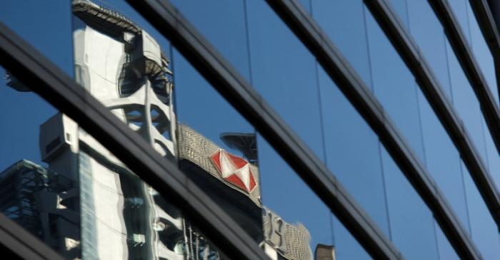 FILE PHOTO: The HSBC headquarters is reflected on the facade of a commercial building in Hong