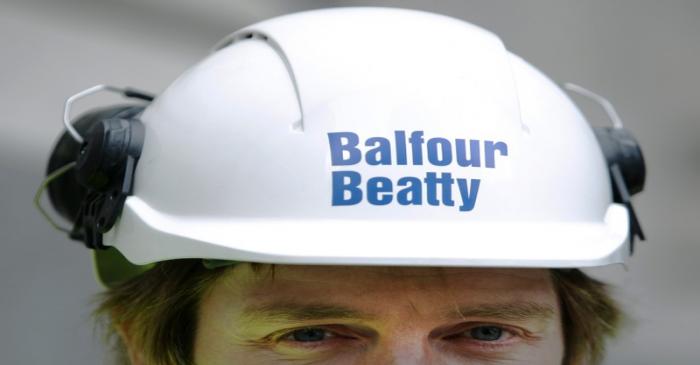 A Balfour Beatty worker walks onto a site in London