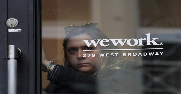 FILE PHOTO: A woman exits a WeWork co-working space in New York