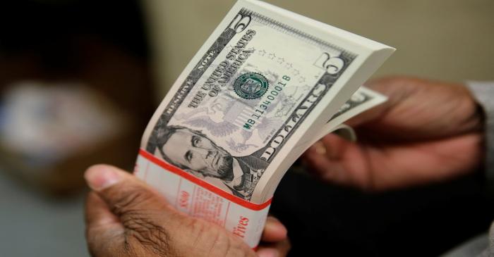 A packet of U.S. five-dollar bills is inspected at the Bureau of Engraving and Printing in