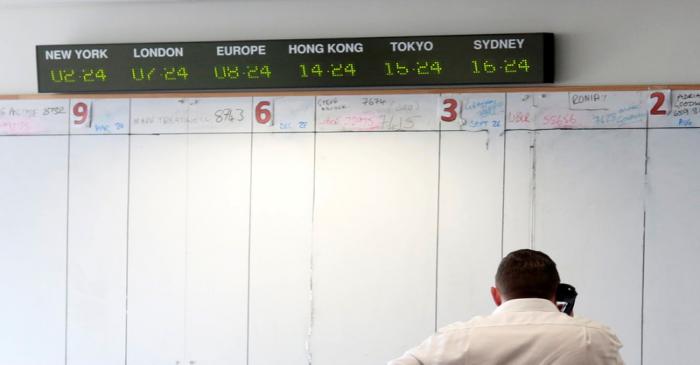 Traders from BGC, a global brokerage company in London's Canary Wharf financial centre wait for