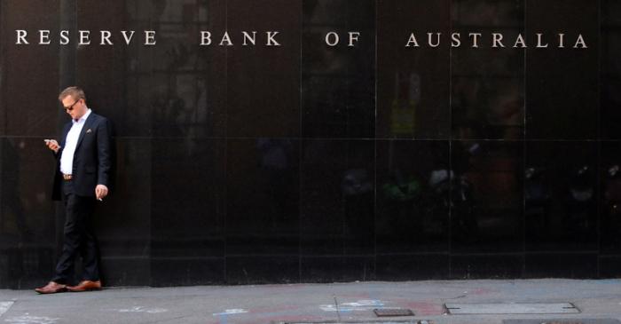 A man smokes next to the Reserve Bank of Australia headquarters in central Sydney