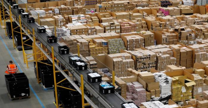 A worker moves boxes at Amazon's fulfilment centre in Peterborough