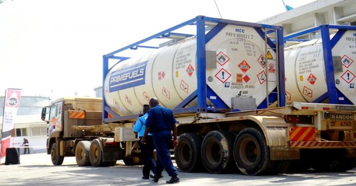 FILE PHOTO: Tanker trucks that used to haul oil products, ferry the crude oil during a pilot