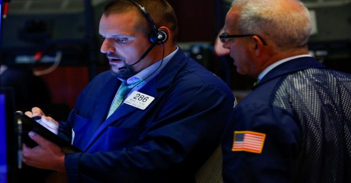 Traders work on the floor at the New York Stock Exchange (NYSE) in New York