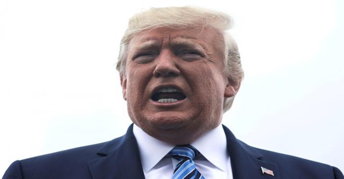 FILE PHOTO: FILE PHOTO: U.S. President Trump talks to reporters as he boards Air Force One for