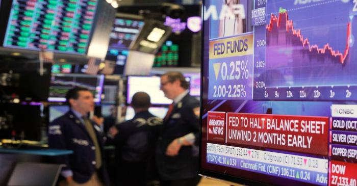 FILE PHOTO:  A screen displays the U.S. Federal Reserve interest rates announcement as traders