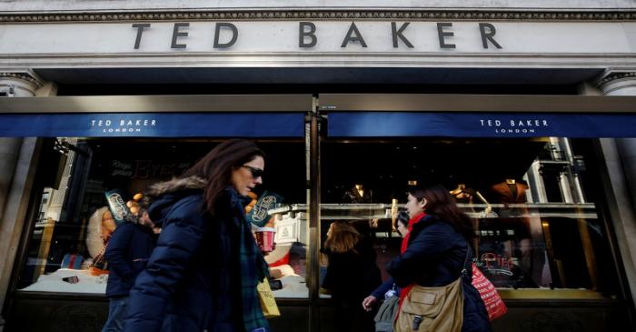 FILE PHOTO: Shoppers walk past a Ted Baker store on Regents Street in London