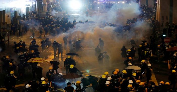 FILE PHOTO: Anti-extradition demonstrators run from tear gas after a march of to call for