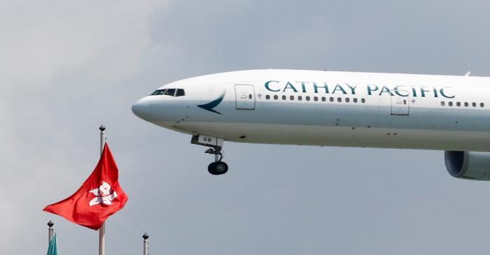 FILE PHOTO: A Cathay Pacific Boeing 777 plane lands at Hong Kong airport after it reopened