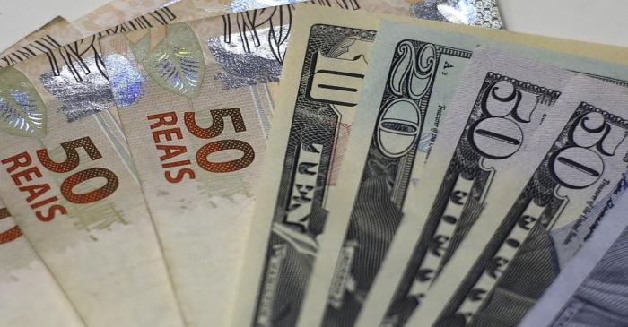 FILE PHOTO: Brazilian real and U.S. dollar notes are pictured at a currency exchange office in