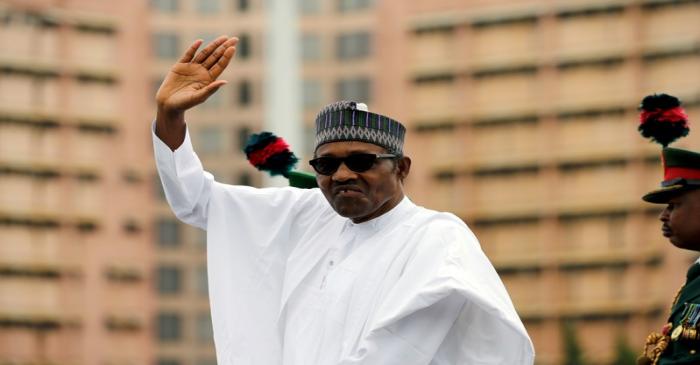 FILE PHOTO: Nigerian President Muhammadu Buhari waves at the crowd while he drives around the