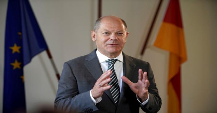 FILE PHOTO: German Finance Minister Olaf Scholz poses for a portrait during an interview with