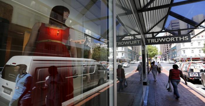 FILE PHOTO: Pedestrians walk past a branch of South African clothing retailer Truworths in Cape