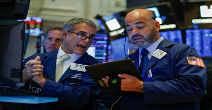 Traders work on the floor at the New York Stock Exchange (NYSE) in New York