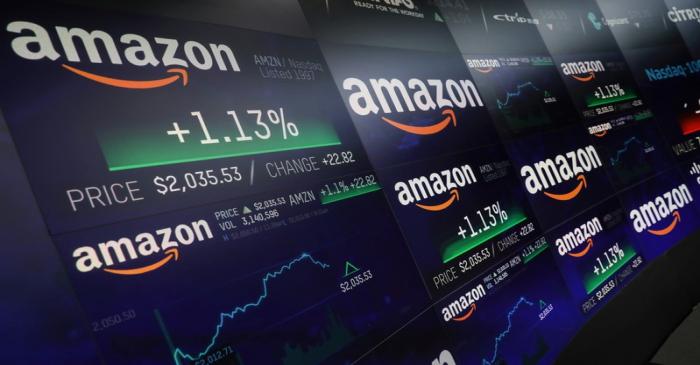 FILE PHOTO: The Amazon.com logo and stock price information is seen on screens at the Nasdaq