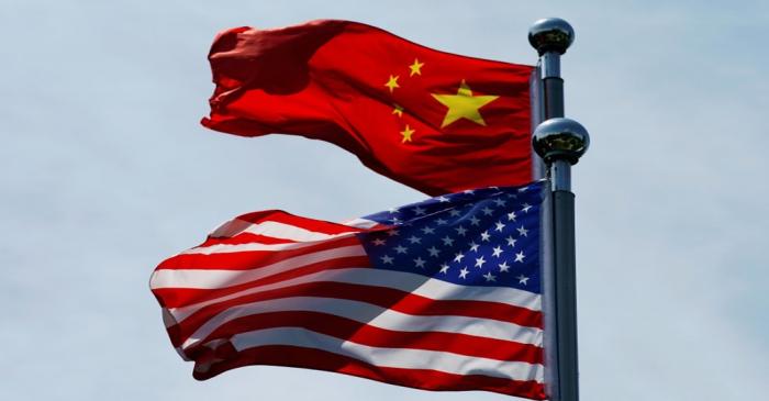 FILE PHOTO:  Chinese and U.S. flags flutter near The Bund in Shanghai