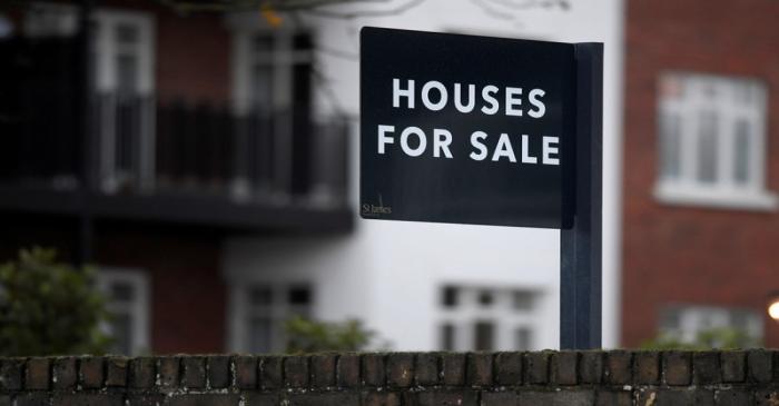 FILE PHOTO: Property sale signs are seen outside of a group of newly built houses in west
