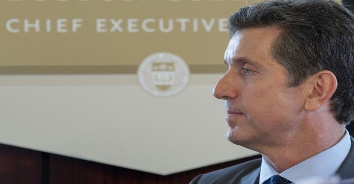 Alex Gorsky, CEO of Johnson & Johnson, listens as he is introduced to speak at the Boston