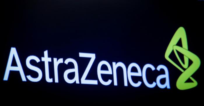 The company logo for pharmaceutical company AstraZeneca is displayed on a screen on the floor