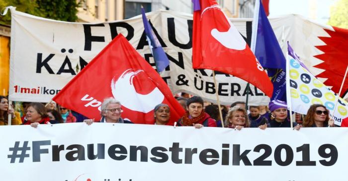 Protesters carry a banner during a May Day demonstration in Zurich