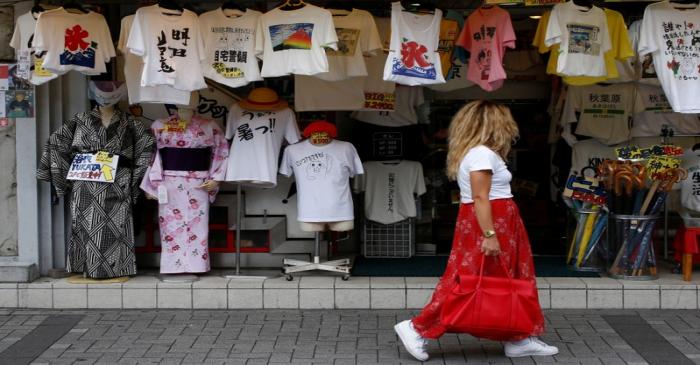 A tourist walks past a souvenir shop at Akihabara district in Tokyo