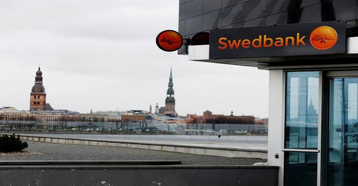 Swedbank signs are seen on the bank's Latvian head office in Riga