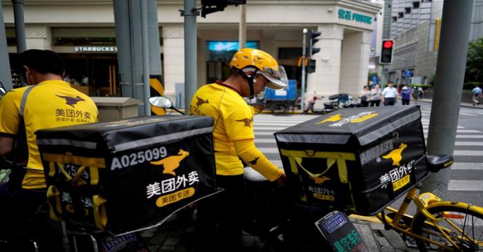 Drivers of food delivery service Meituan are seen in Shanghai