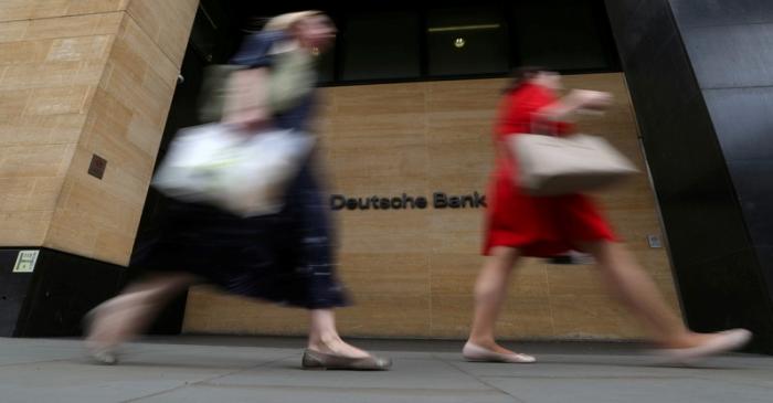 FILE PHOTO: People walk past a Deutsche Bank office in London