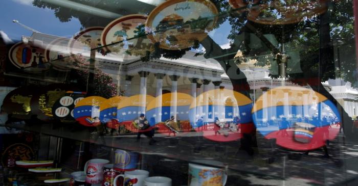 National Assembly building is reflected in a window of a store in Caracas