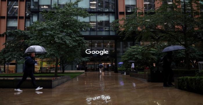 People walk past the Google headquarters in the Kings Cross area in London