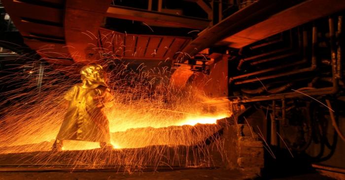FILE PHOTO: A worker uses the tapping process to separate nickel ore from other elements at a
