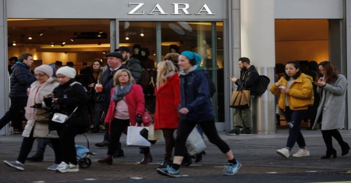 Shoppers walk past a Zara Store on Oxford Street in London